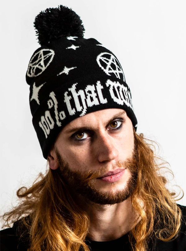 Man modeling a black beanie with text that reads &quot;100% that witch&quot; with a black pom pom on top